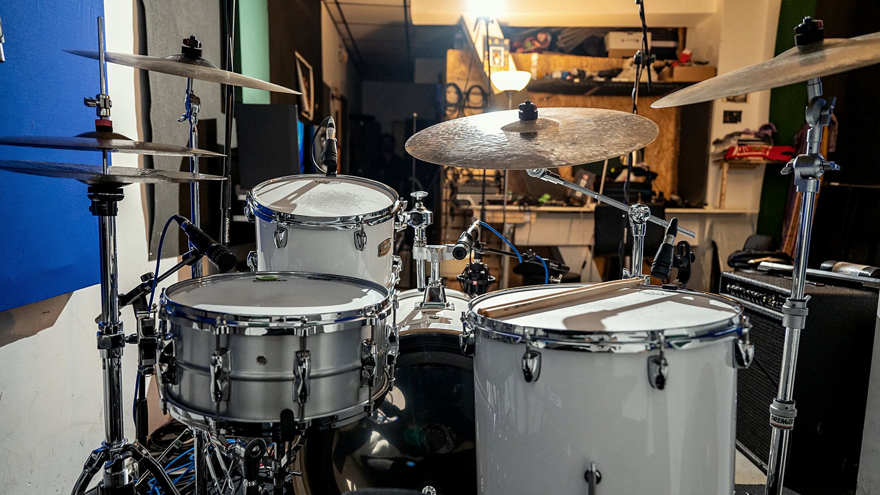 The kit set up and miked in the studio, seen from behind the drums.